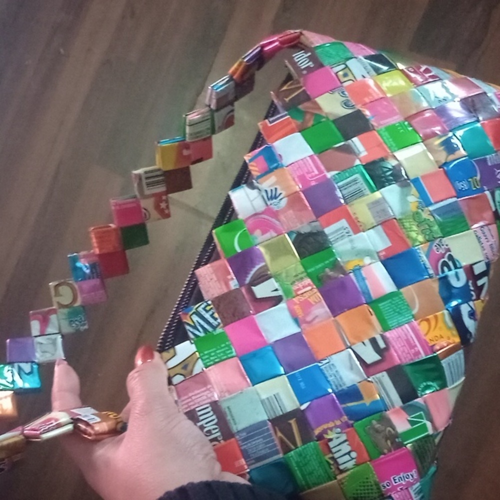 Custom made shoulder bag made with candy wrappers from different countries